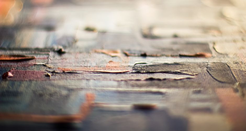 Detailed view of textured oil painting showcasing vibrant brush strokes and layered colors.